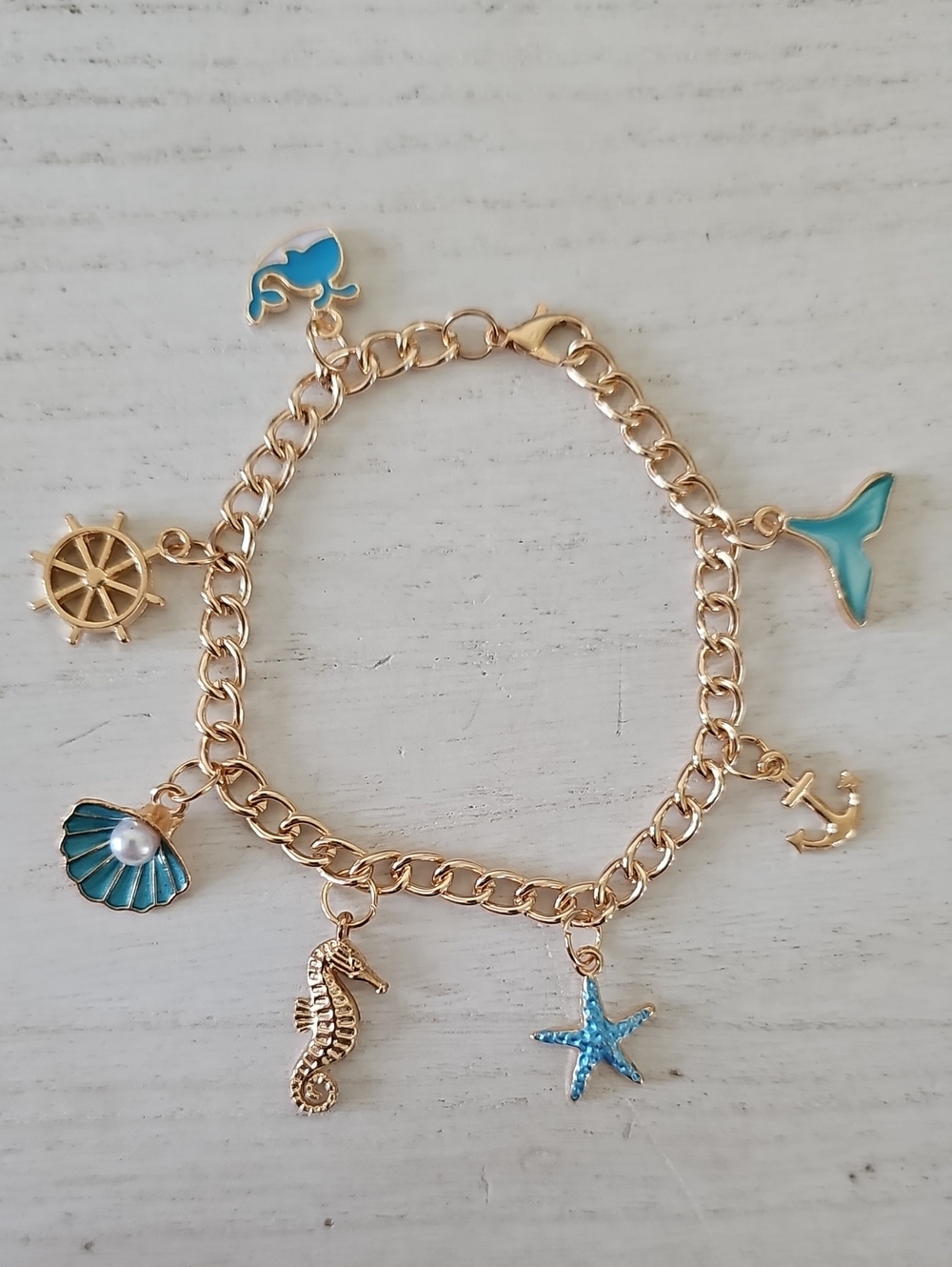 Gold Tone Ocean Charm Bracelet with Blue Accents